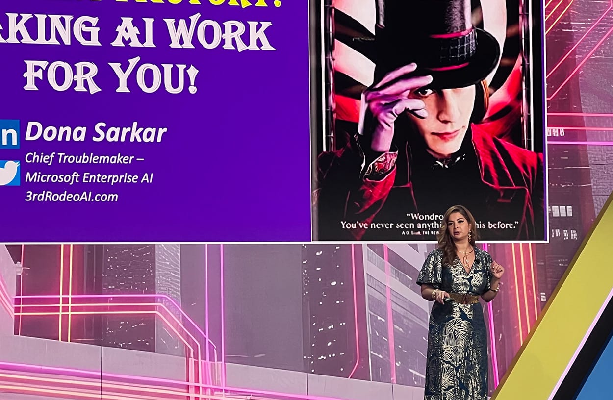 Image shows Dona Sarkar talking to business leaders at the NCA SOTIC