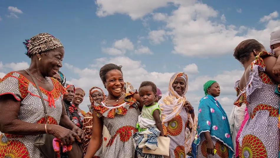 Image shows a group of happy female cocoa farmers