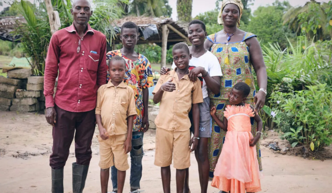 Image shows a cocoa-growing family in Cote d'Ivoire