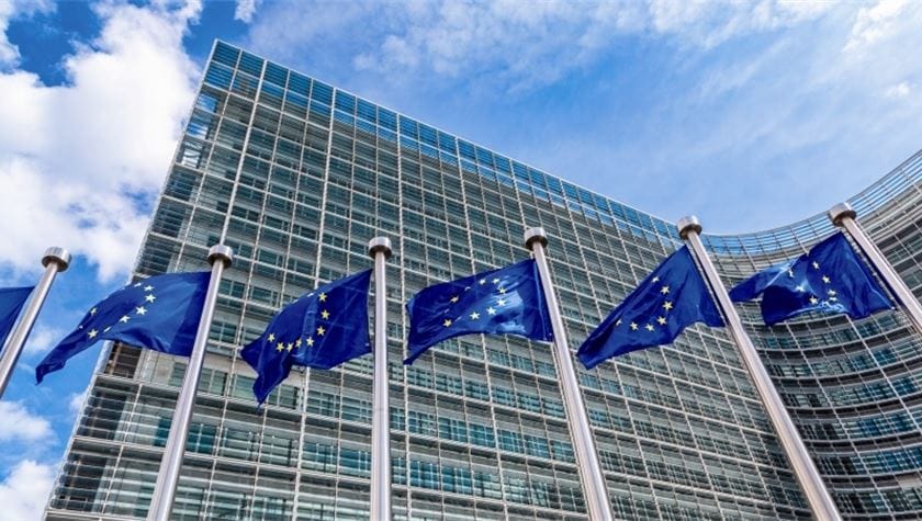 Image shows European flags flying outside the EC headquarters in Brussels. 